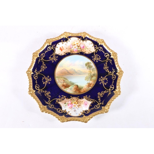 422 - Aynsley porcelain cabinet plate, the central vignette depicting a lake scene with two further floral... 