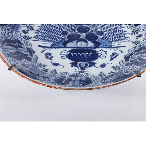 459 - Antique Dutch tin glazed blue and white charger dish, decorated with urn of flowers, painted marks t... 