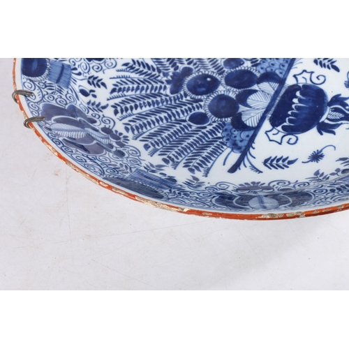 459 - Antique Dutch tin glazed blue and white charger dish, decorated with urn of flowers, painted marks t... 