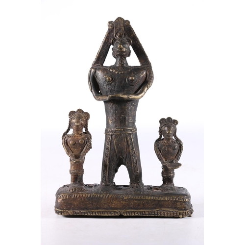 464 - African Benin style cast metal figure group the central large figure flanked by smaller figures, 21.... 