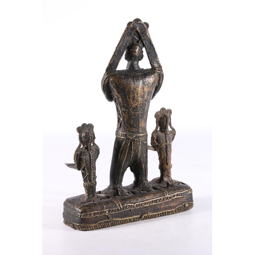 464 - African Benin style cast metal figure group the central large figure flanked by smaller figures, 21.... 