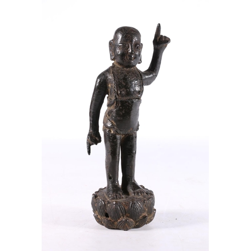 465 - Antique Chinese cast bronze figure of buddha type character moulded standing with finger raised wear... 