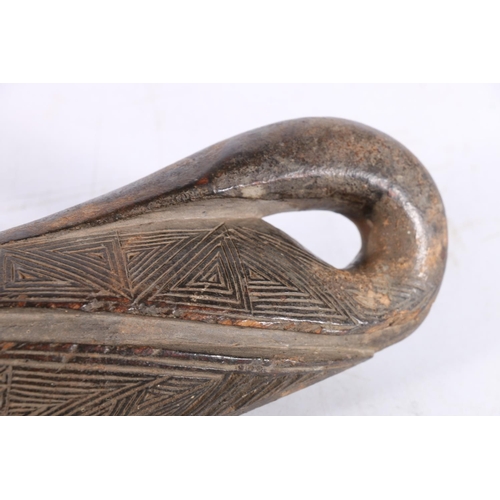 477 - African or Oceanic carved wood winder, incised with geometric pattern, 19cm long.