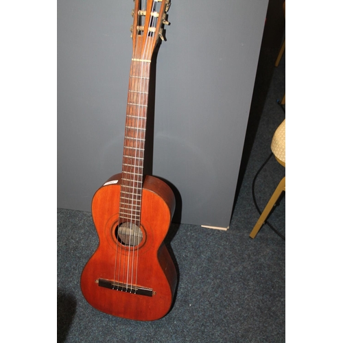 243 - Acoustic guitar with elongated body, with hard case.