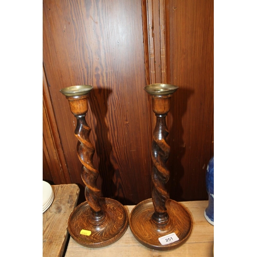 251 - Pair of oak barley twist candlesticks.