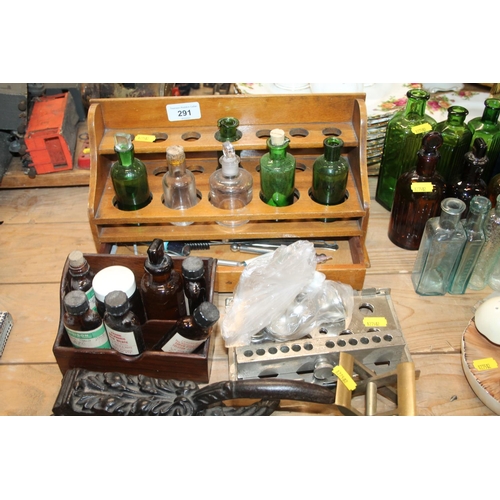 291 - Apothecary rack containing chemist jars, a pill board, etc.