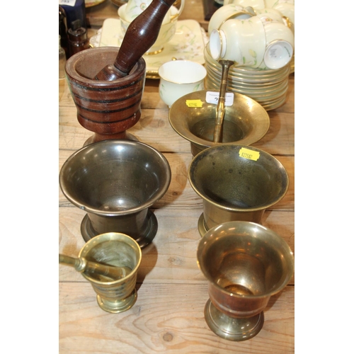 294 - Two bronze pestles and mortars, and others.