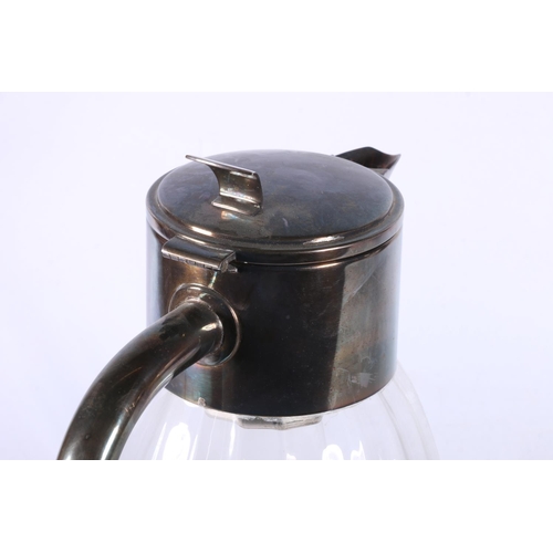 10 - Hammered metal ice bucket with leather handle, and a glass metal mounted teapot.