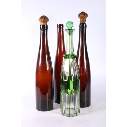 103 - Green flash cut glass decanter and three brown glass ale bottles.