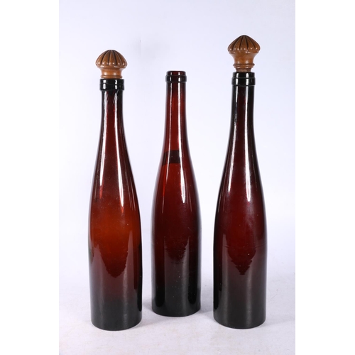 103 - Green flash cut glass decanter and three brown glass ale bottles.