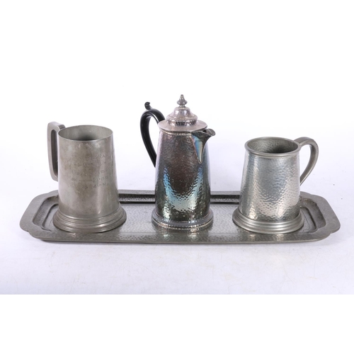 123 - Planished pewter tray, tankard and water pot and another tankard,  (4).