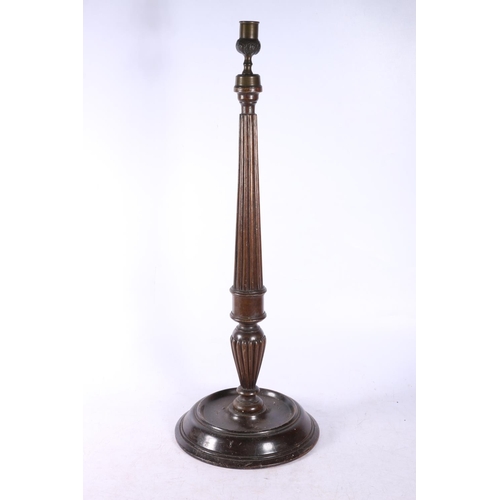 124 - Reeded mahogany candlestick, 54cm.