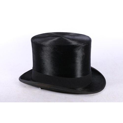 125 - London Manufacture top hat with fitted leather box, gloves and tie.