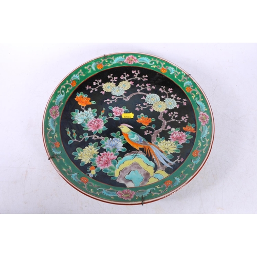 143 - Two Chinese wall plates decorated with birds amongst flowers, largest measures 31cm.