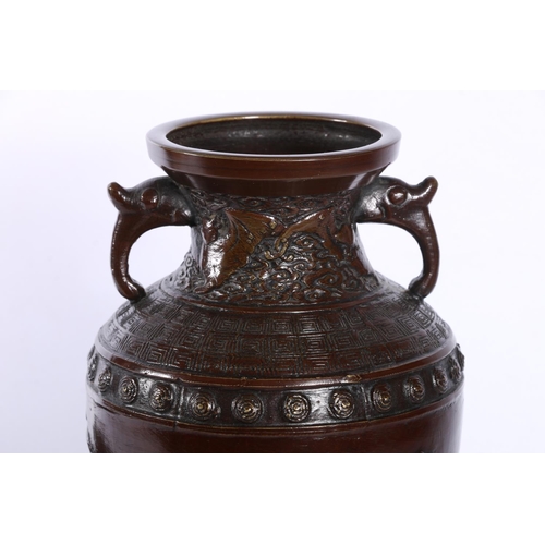 17 - Pair of oriental bronzed twin-handled vases with relief decoration.