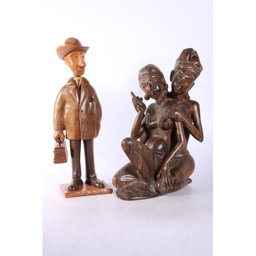 22 - Carved Eastern figure of a couple, and another humorous carved wood figure of a gentleman.