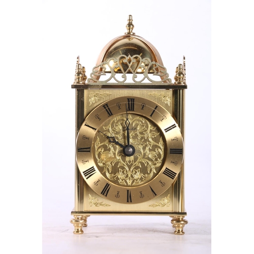 24 - Brass Ware to include a lantern type clock, a pair of clogs, a hand bell, etc.