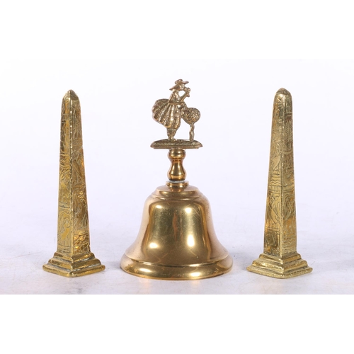 24 - Brass Ware to include a lantern type clock, a pair of clogs, a hand bell, etc.