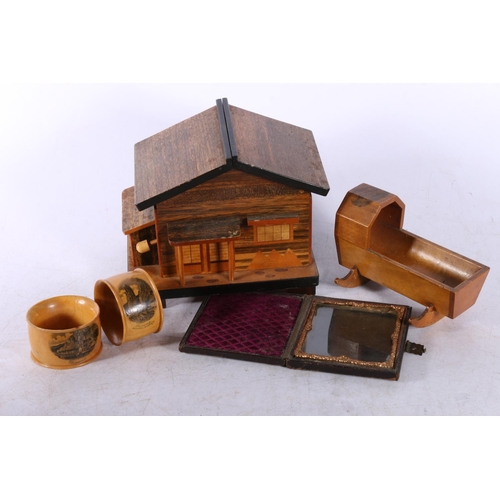 29 - Mauchline Ware crib, two similar napkin rings, a cigarette box in the form of a Swiss chalet, and a ... 