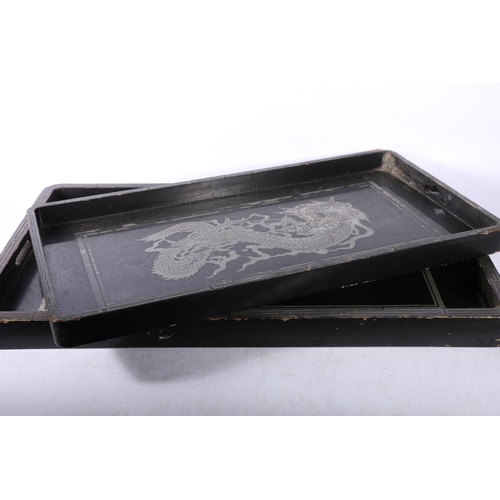 73 - Two Chinese lacquered trays decorated with dragons, largest measures 61cm x 36cm.