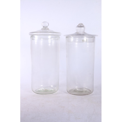 75 - Two antique lidded glass storage jars, 29cm.