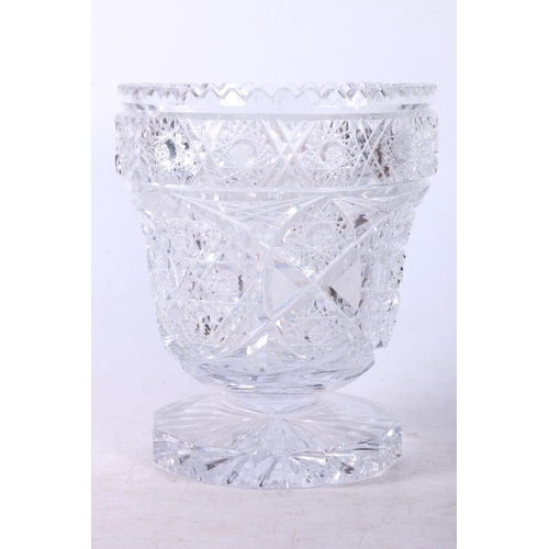 76 - Heavily cut glass footed vase, 21cm.