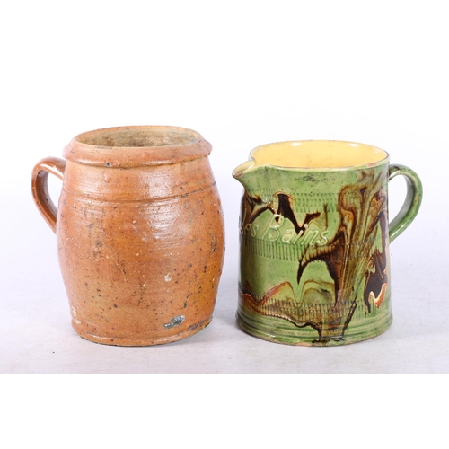 82 - Terracotta tankard, and a French slipware style jug.  (2)