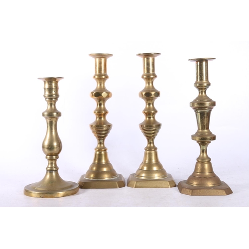 83 - Four brass candlesticks, and three small brass pots.