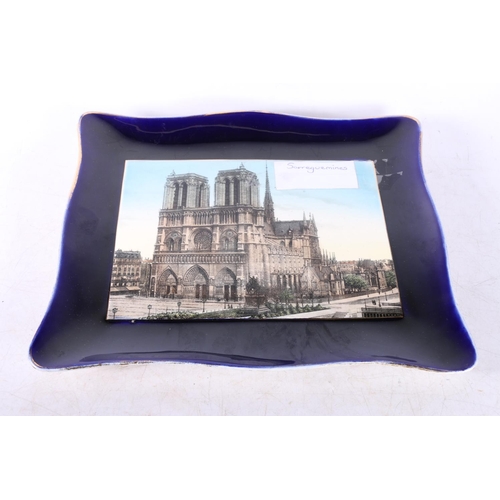 85 - Sarreguemines shallow dish of square form, the central panel decorated with Notre Dame, 32cm x 27cm.