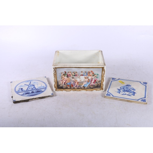 90 - Two early Delft style tiles and a Napoli porcelain box decorated with classical scene, box measures ... 