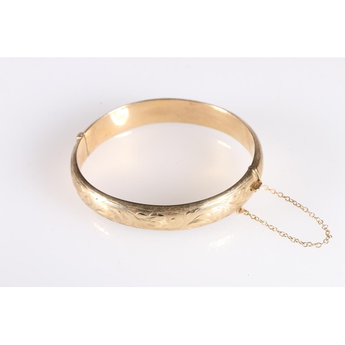 102 - 9ct gold hollow bangle with engraved decoration, 13.3g gross.