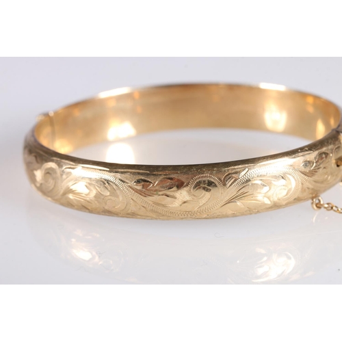 102 - 9ct gold hollow bangle with engraved decoration, 13.3g gross.