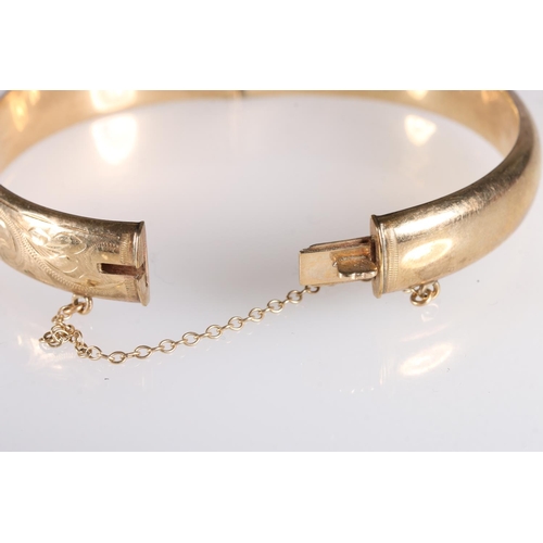 102 - 9ct gold hollow bangle with engraved decoration, 13.3g gross.