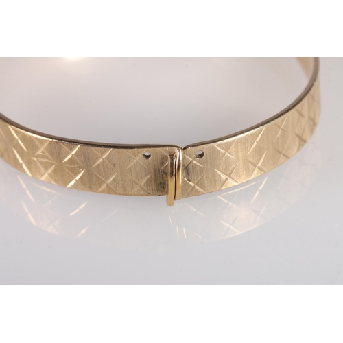 103 - Contemporary 9ct gold bangle with cross design, makers Maylin Products Ltd of London, further stampe... 