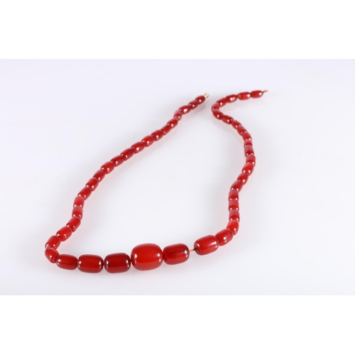 118 - Large single strand necklace of graduated cherry red amber beads, the largest bead over 2.5cm long, ... 