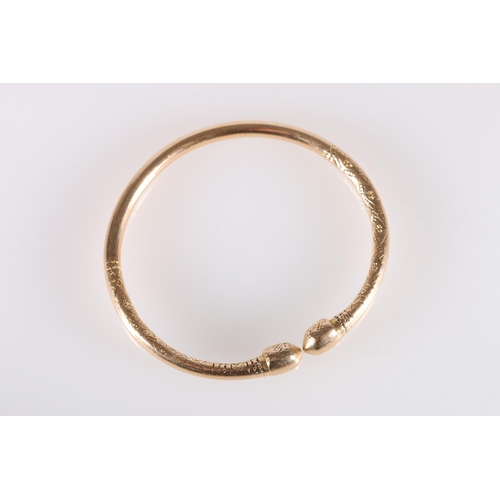 125 - 18ct gold West Indian torque shaped bayras bangle with incised decoration, stamped '18ct', 48.5g.