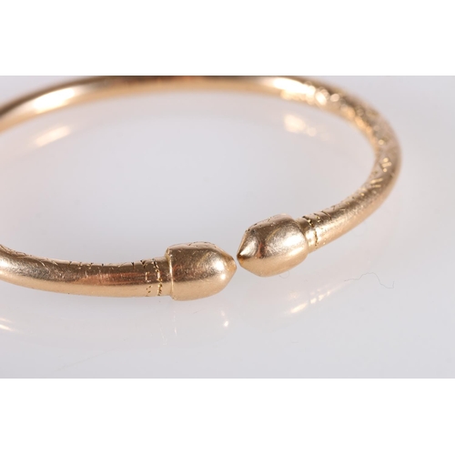 125 - 18ct gold West Indian torque shaped bayras bangle with incised decoration, stamped '18ct', 48.5g.