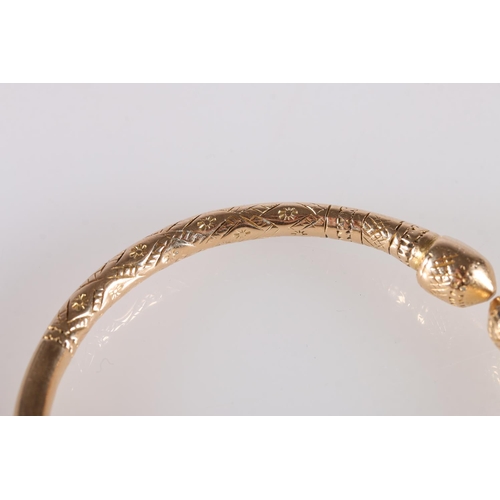 125 - 18ct gold West Indian torque shaped bayras bangle with incised decoration, stamped '18ct', 48.5g.