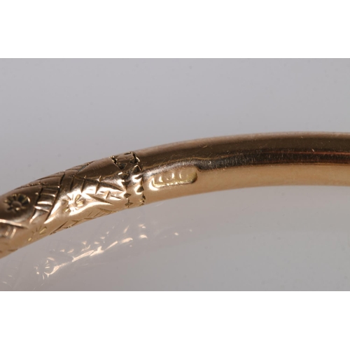 125 - 18ct gold West Indian torque shaped bayras bangle with incised decoration, stamped '18ct', 48.5g.