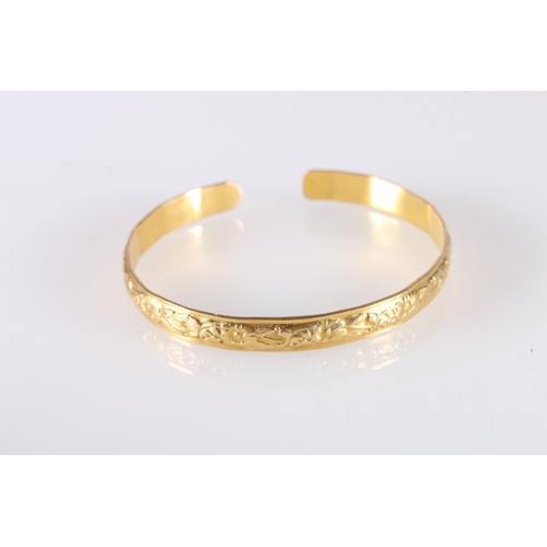 127 - Yellow gold coloured yellow metal West Indian bayras bangle with floral pattern, unhallmaked, 20.7g ... 