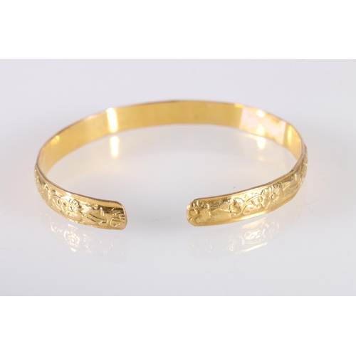 127 - Yellow gold coloured yellow metal West Indian bayras bangle with floral pattern, unhallmaked, 20.7g ... 