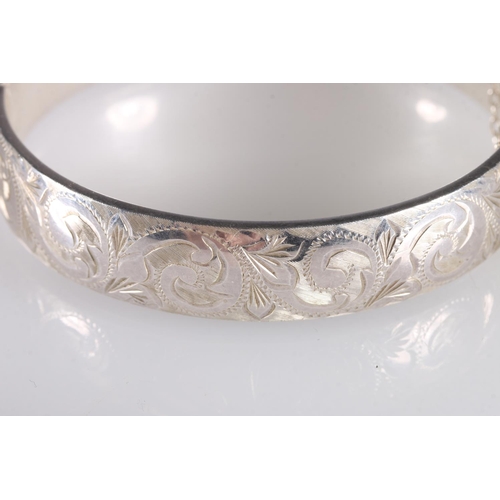 148 - Georg Jensen hinged bangle with foliate decoration to one side hallmarked GJLd, london 1964, 6cm, 24... 