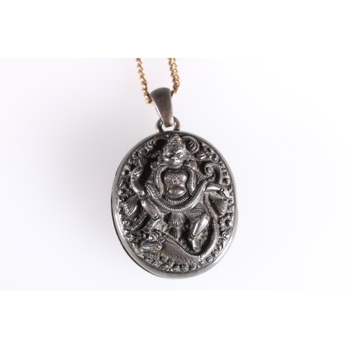 149 - Late 19th early 20th century white metal locket with deity entwined by serpent to front, 3.5cm. ... 