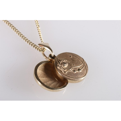 158 - 9ct gold photo locket with foliate design to one side, on 9ct gold chain, 16g gross. 