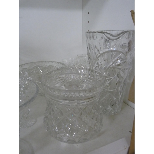 107 - Collection of cut and other glass including jugs, vases, bowls etc (one shelf).