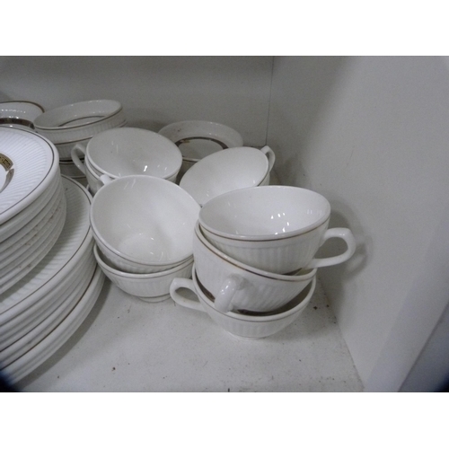 117 - Extensive Wedgwood 'Insignia' tea and breakfast set (two shelves).