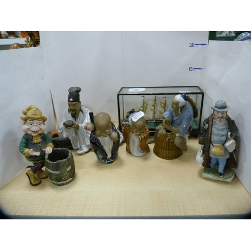 154 - Collection of oriental figures and a diorama-style model of a ship.