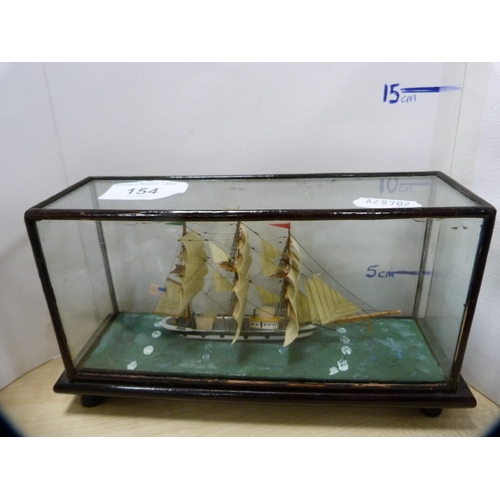 154 - Collection of oriental figures and a diorama-style model of a ship.