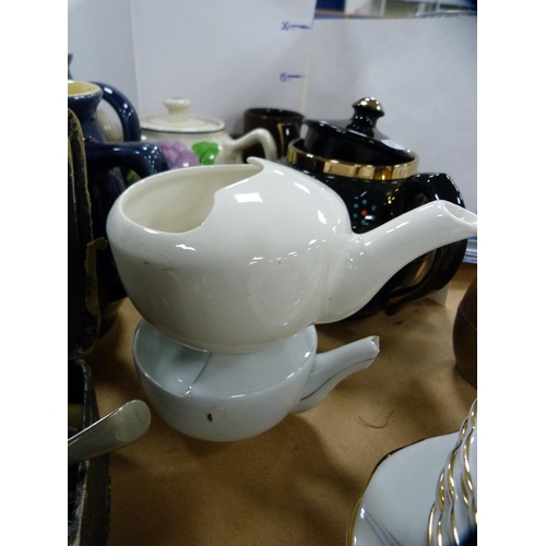 205 - Collection of assorted glazed teapots and jugs to include a Denby blue glazed jug etc.