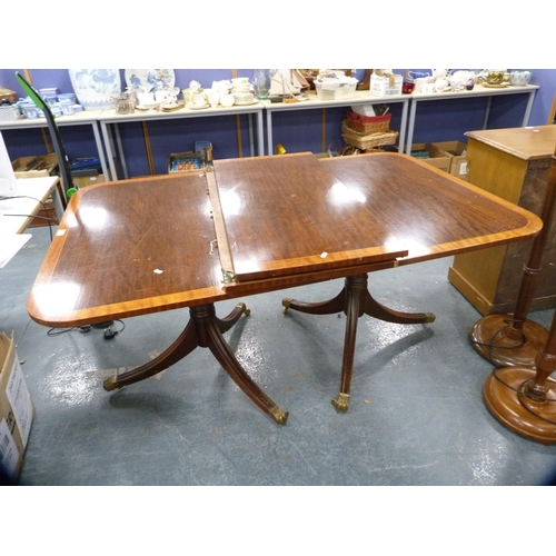 393 - Reproduction twin-pedestal dining table with two additional leaves, on brass paw feet and cappings, ... 